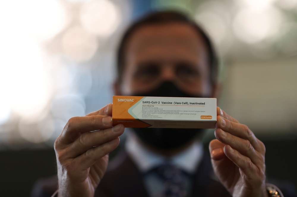 Brazil's Sao Paulo state governor, Joao Doria holds a box of the China's Sinovac coronavirus potential vaccine for trials during a news conference at Hospital das Clinicas, in Sao Paulo, Brazil July 21, 2020. REUTERS/Amanda Perobelli