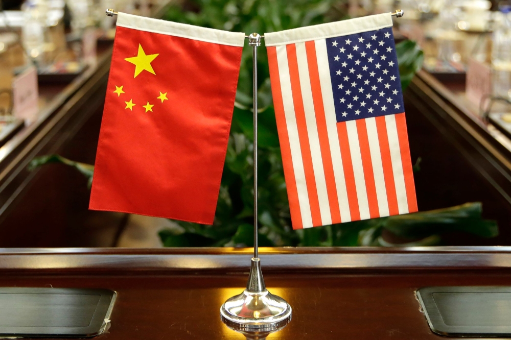 (FILES) In this file photo taken on June 30, 2017, flags of the US and China are placed ahead of a meeting at the Ministry of Agriculture in Beijing. AFP / POOL / JASON LEE