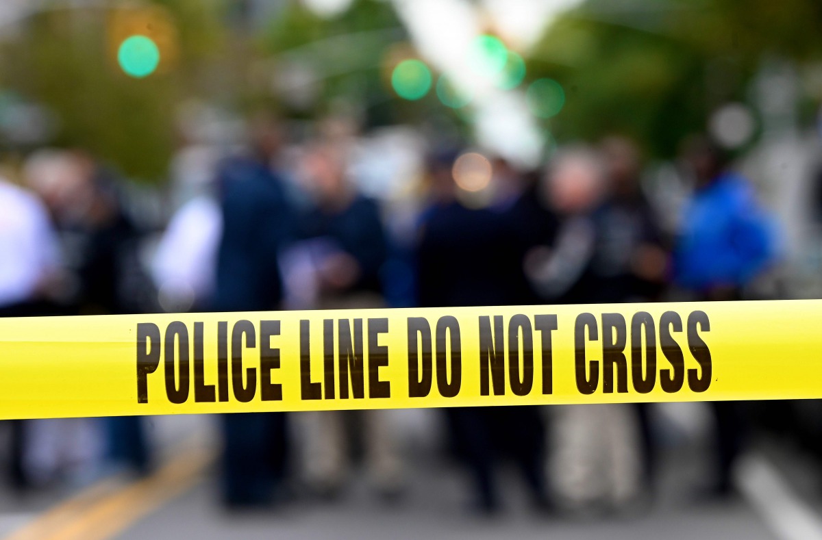 (FILES) In this file photo taken on October 12, 2019 Police tape secures a crime scene outside a club after a shooting in Brooklyn . \/ AFP / Johannes EISELE