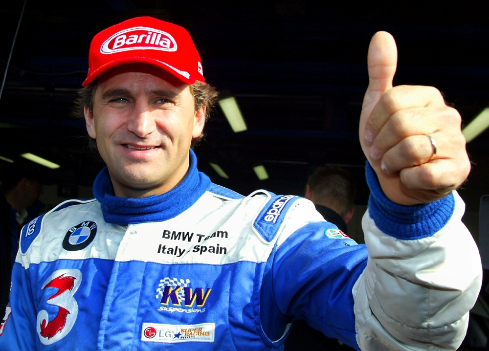 Alex Zanardi gives a thumbs up before the start of an LG Super Racing car event at the Monza race track October 19, 2003. REUTERS/Giampiero Sposito/File Photo