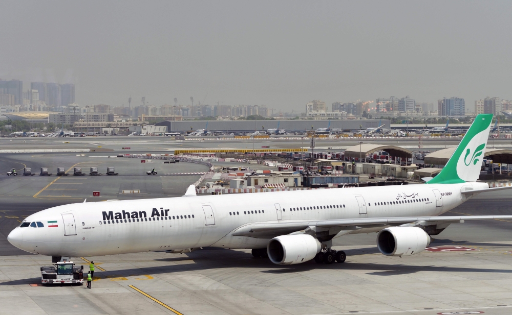 (FILES) In this file photo taken on September 14, 2017, an Iranian airliner Mahan Air Airbus A340 aircraft is seen at the tarmac at Dubai International Airport. AFP / GIUSEPPE CACACE