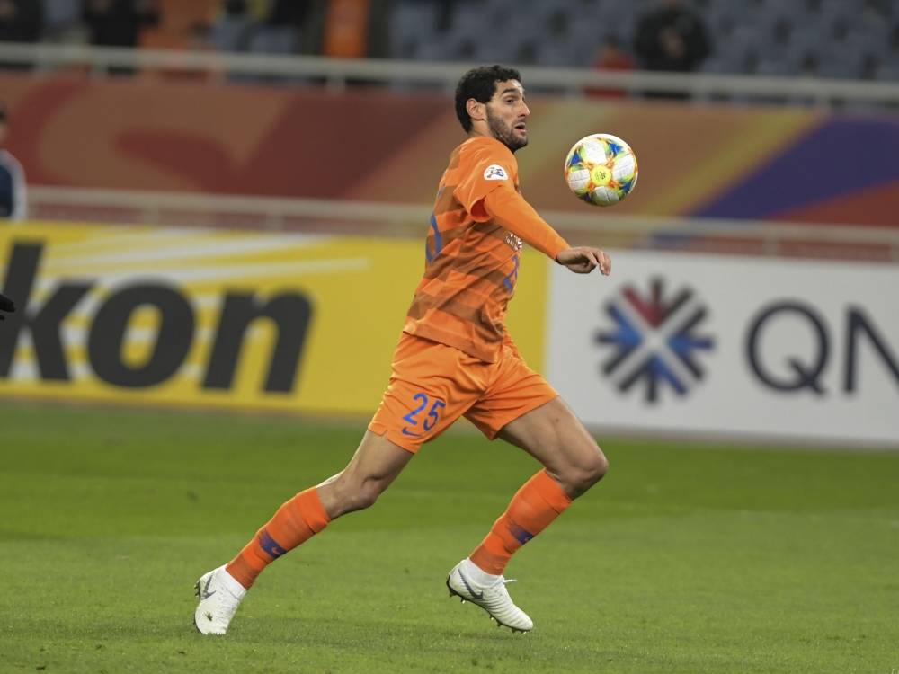 This file photo taken on April 9, 2019 shows Shandong Luneng's Marouane Fellaini running with the ball during the AFC Champions League group stage football match between China's Shandong Luneng and Malaysia's Johor Darul Ta'zim in Jinan in China's eastern