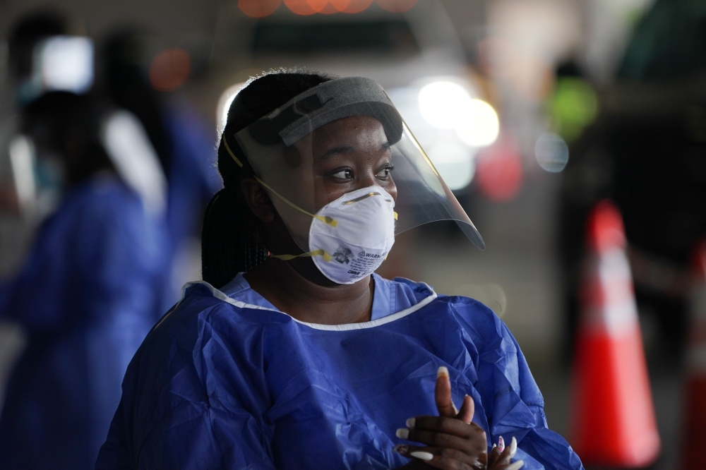 A medical worker in PPE looks on at a drive-thru COVID-19 testing site at the Mahaffey Theater on July 24, 2020 in St. Petersburg, Florida. Florida reported a record daily coronavirus death toll of 173 on July 23, 2020, in the latest reflection of the COV