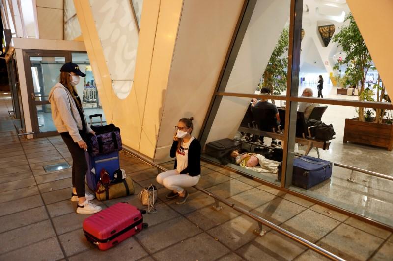 FILE PHOTO: Tourists wait to be repatriated to their countries as Morocco suspends flights to European countries over coronavirus (COVID-19) fears, at Marrakech airport, Morocco, March 14, 2020. REUTERS/Youssef Boudlal