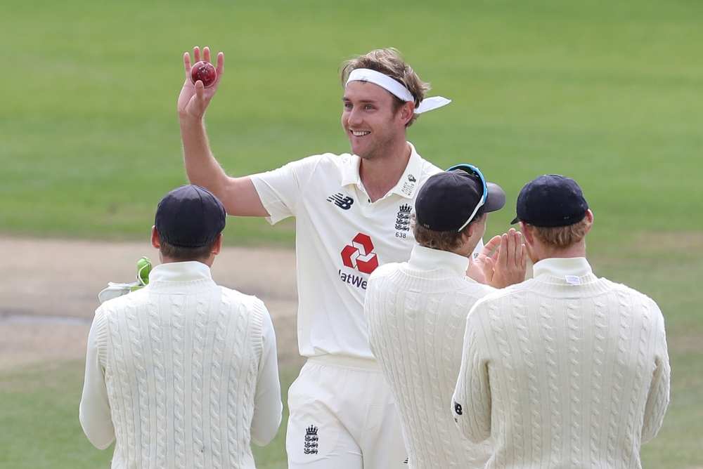 Cricket - Third Test - England v West Indies - Emirates Old Trafford, Manchester, Britain - July 28, 2020 England's Stuart Broad celebrates taking his 500th test wicket with teammates after taking the wicket of West Indies' Kraigg Brathwaite, as play resu