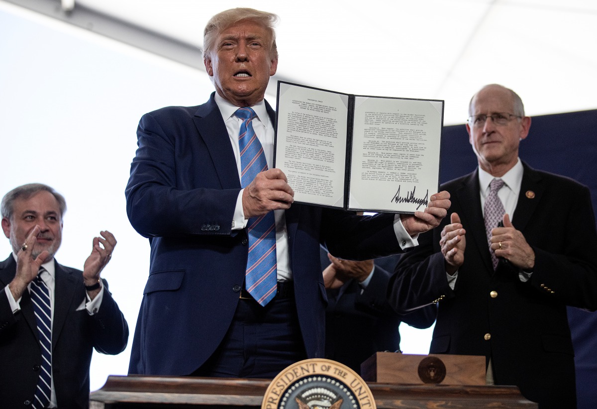 U.S. President Donald Trump is applauded as he displays a presidential permit for energy development that he signed during a tour of the Double Eagle Energy Oil Rig in Midland, Texas, U.S., July 29, 2020. REUTERS/Carlos Barria