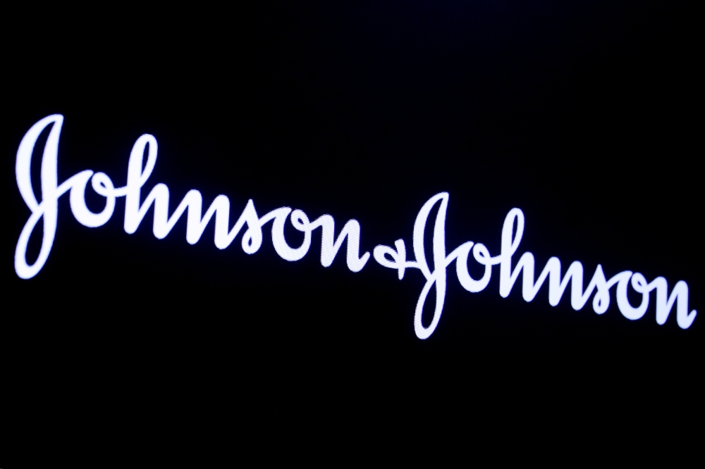 FILE PHOTO: The company logo for Johnson & Johnson is displayed on a screen to celebrate the 75th anniversary of the company's listing at the New York Stock Exchange (NYSE) in New York, U.S., September 17, 2019. REUTERS/Brendan McDermid/File Photo