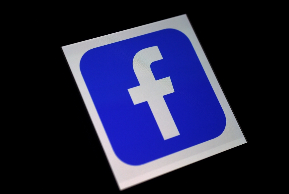 In this file illustration photo taken on March 25, 2020 a Facebook App logo is displayed on a smartphone in Arlington, Virginia. Facebook reported July 30, 2020, that its quarterly profit had nearly doubled and users grew despite a boycott by advertisers.