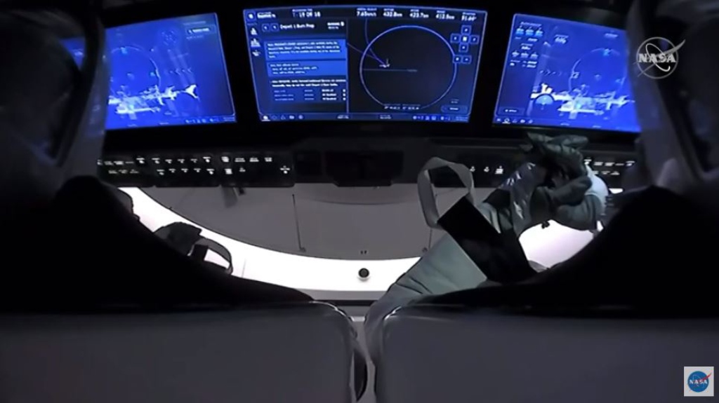 This NASA video frame grab image shows SpaceX’s Crew Dragon spacecraft with NASA astronauts Douglas Hurley and Robert Behnken watching on their screens an infrared view of the International Space Station after undocking from it on August 1, 2020. / AFP / 