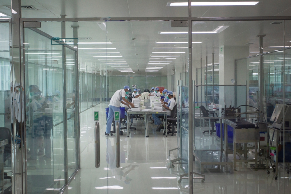 Staff are seen in the COVID-19 vaccine production facility area at the Bio Farma office amid the coronavirus pandemic in Bandung, West Java province, Indonesia August 4, 2020. Antara Foto/Dhemas Reviyanto 