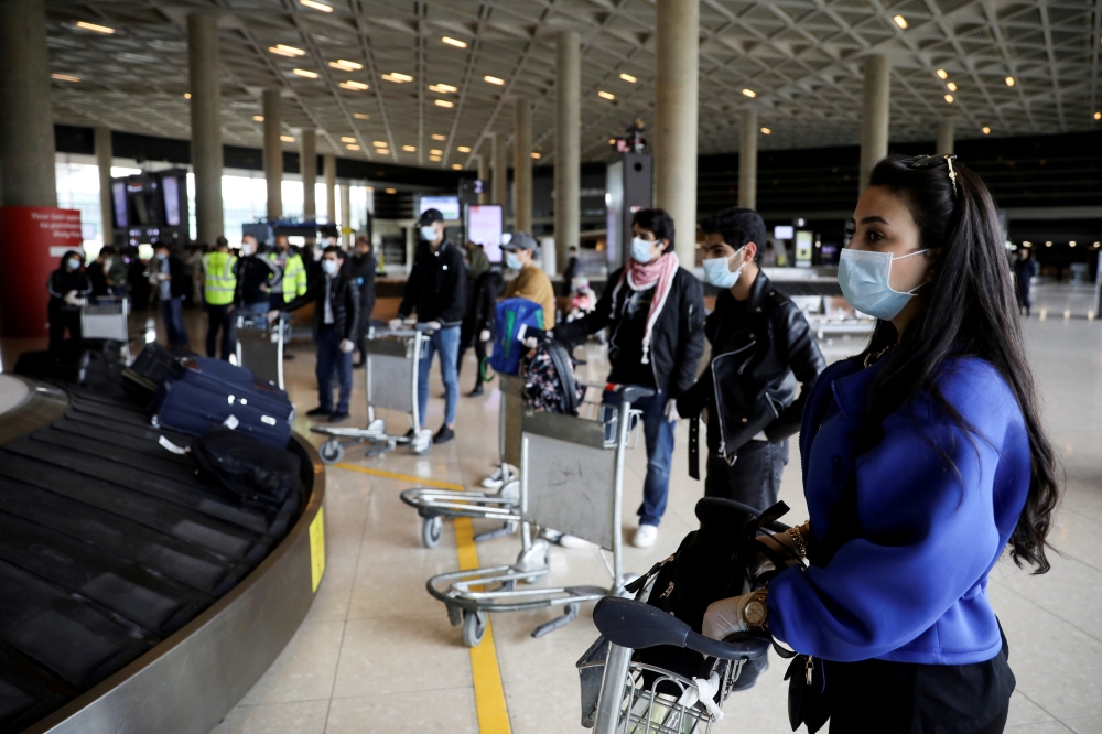 FILE PHOTO: Jordanian students who were studying abroad await their luggage after returning home amid concerns over the spread of the coronavirus, at Queen Alia International Airport in Amman, Jordan, May 6, 2020. REUTERS/Muhammad Hamed/File Photo
