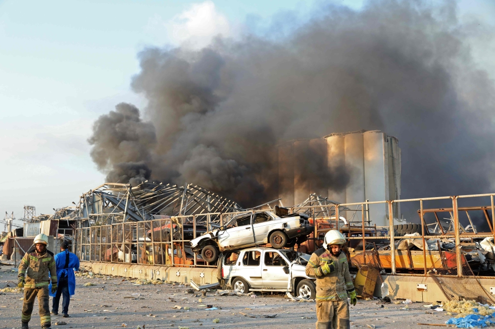 A picture shows the scene of an explosion at the port in Beirut on August 4, 2020. Two huge explosion rocked the Lebanese capital Beirut, wounding dozens of people, shaking buildings and sending huge plumes of smoke billowing into the sky. Lebanese media 