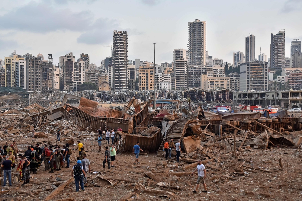 A picture shows the scene of an explosion near the the port in the Lebanese capital Beirut on August 4, 2020. Two huge explosion rocked the Lebanese capital Beirut, wounding dozens of people, shaking buildings and sending huge plumes of smoke billowing in
