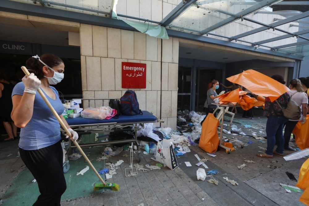 A woman sweeps at a damaged hospital following Tuesday's blast, in Beirut Lebanon August 5, 2020. REUTERS/Mohamed Azakir