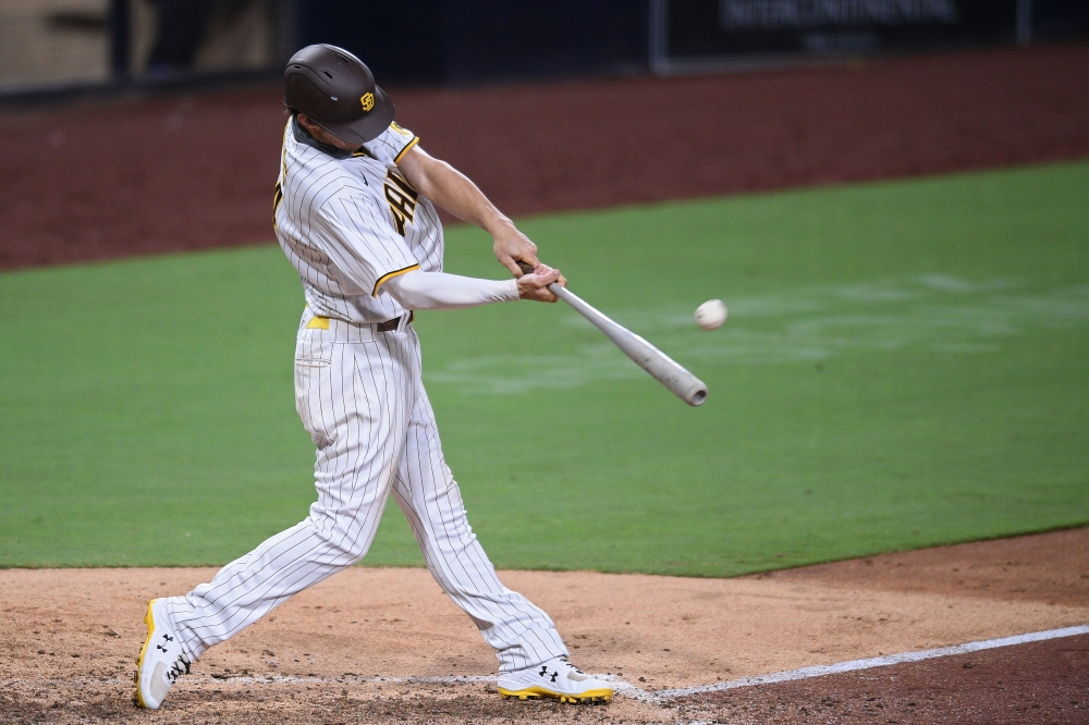 Aug 5, 2020; San Diego, California, USA; San Diego Padres right fielder Wil Myers (4) hits a home run during the eighth inning against the Los Angeles Dodgers at Petco Park. Mandatory Credit: Orlando Ramirez-USA TODAY Sports