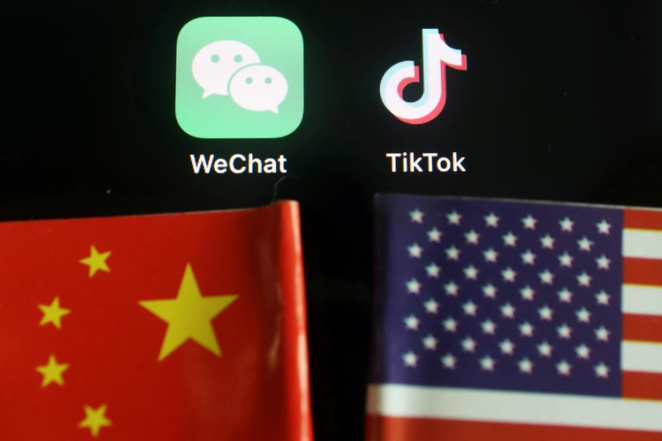 The messenger app WeChat and short-video app TikTok are seen near China and U.S. flags in this illustration picture taken August 7, 2020. REUTERS/Florence Lo/Illustration

