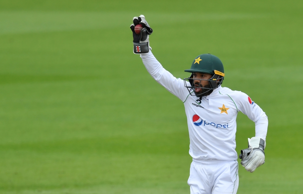 Pakistan's Mohammad Rizwan celebrates catching England's Ben Stokes off the bowling of Pakistan's Yasir Shah, as play resumes behind closed doors following the outbreak of the coronavirus disease (COVID-19) Dan Mullan/Pool via REUTERS