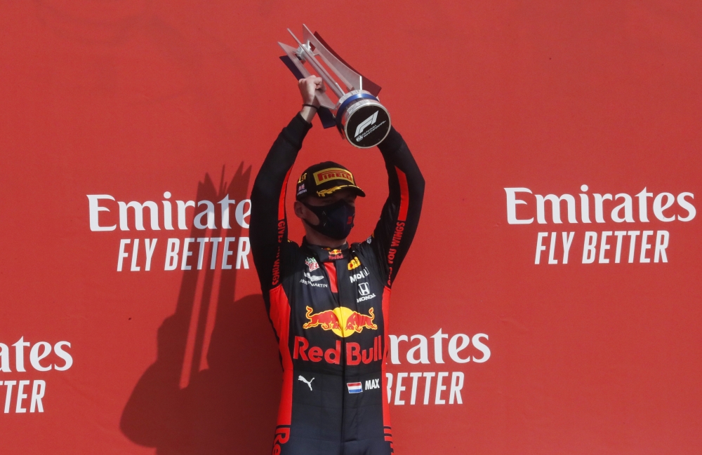 Formula One F1 - 70th Anniversary Grand Prix - Silverstone Circuit, Silverstone, Britain - August 9, 2020 Red Bull's Max Verstappen celebrates his win on the podium after the race Pool via REUTERS/Frank Augstein