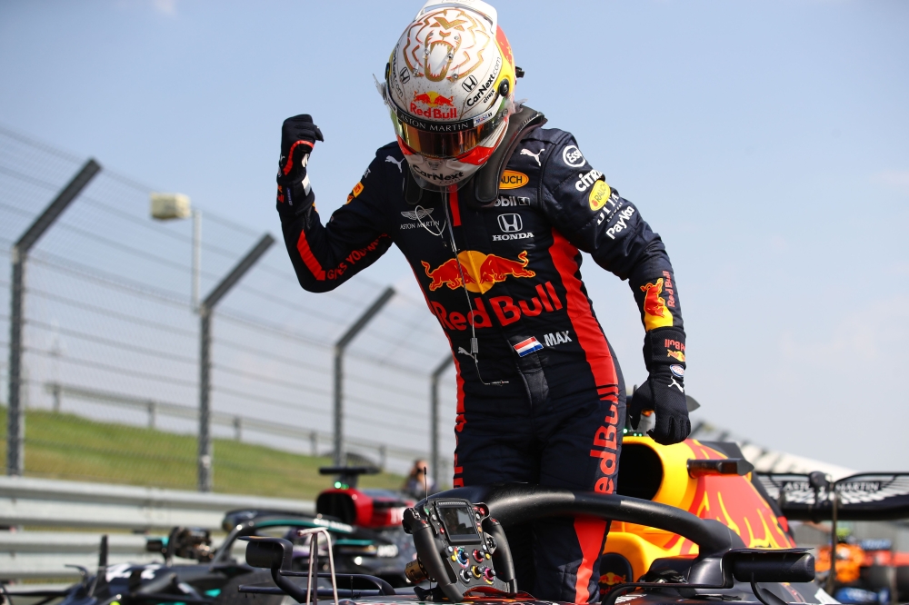 Red Bull's Dutch driver Max Verstappen celebrates after winning the race during the F1 70th Anniversary Grand Prix at Silverstone on August 9, 2020 in Northampton. / AFP / POOL / Bryn Lennon