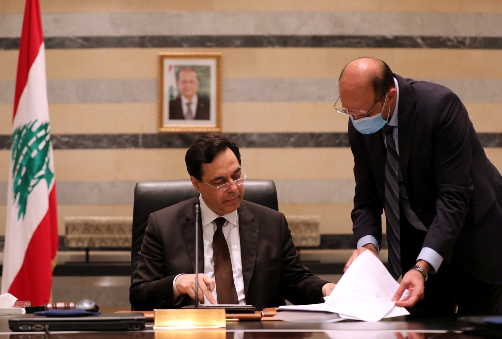 Lebanon's Health Minister Hamad Hasan talks to Lebanon's Prime Minister Hassan Diab during a cabinet meeting at the government palace in Beirut, Lebanon, August 10, 2020. REUTERS/Mohamed Azakir