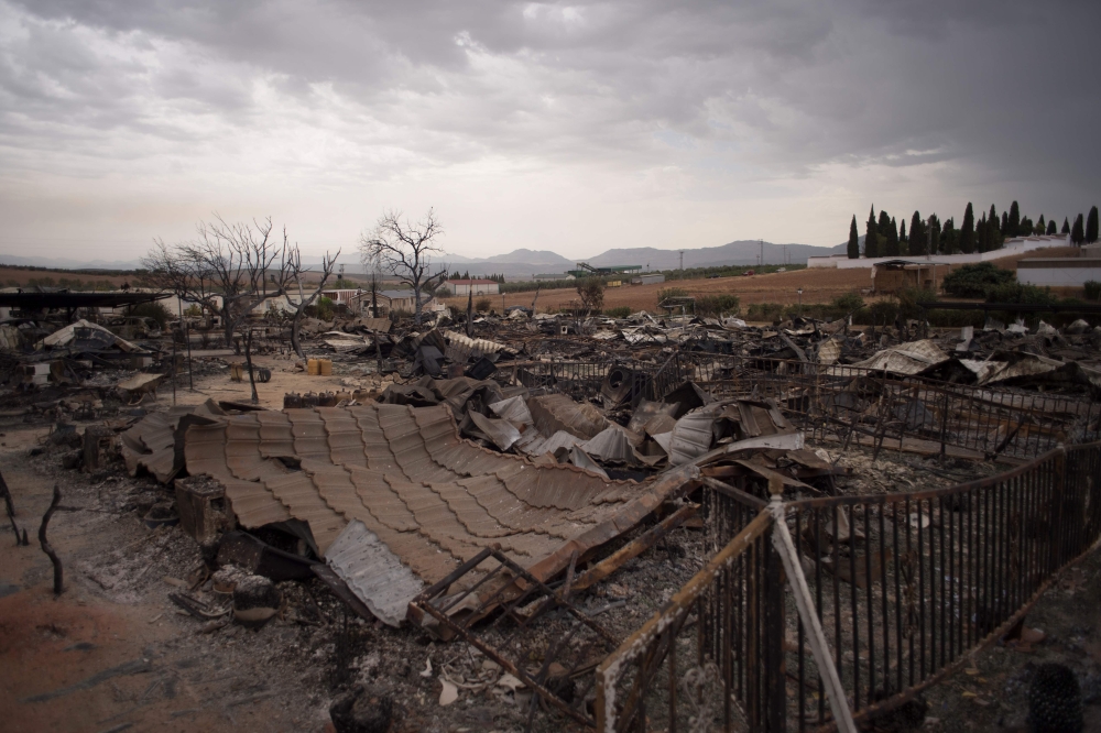 A general view shows a burnt holiday park in Mollina near Malaga on August 10, 2020. A wind-fuelled fire ripped through a holiday park in Spain that is home to a large number of British pensioners, destroying dozens of homes and injuring two people, offic