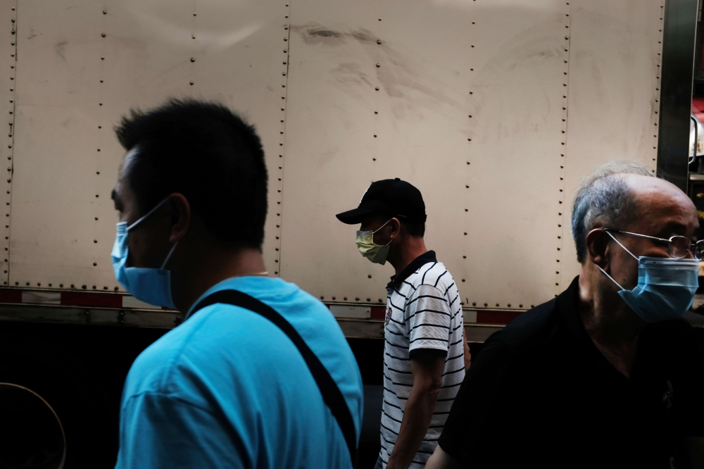 :NEW YORK, NEW YORK - AUGUST 10: People walk through New York City's Chinatown on August 10, 2020 in New York City.  Spencer Platt/ AFP 

