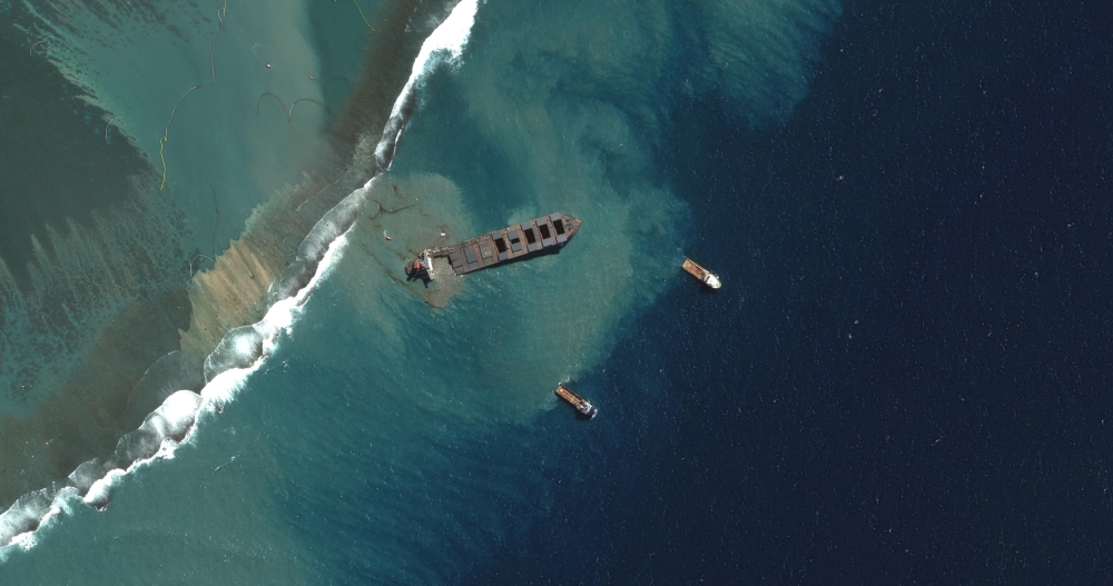 A view shows Japanese bulk carrier ship MV Wakashio as it begins to break apart, after it ran aground on a reef in Mauritius, in this August 15, 2020 satellite image provided by Maxar Technologies. Satellite image ?2020 Maxar Technologies/Handout via REUT