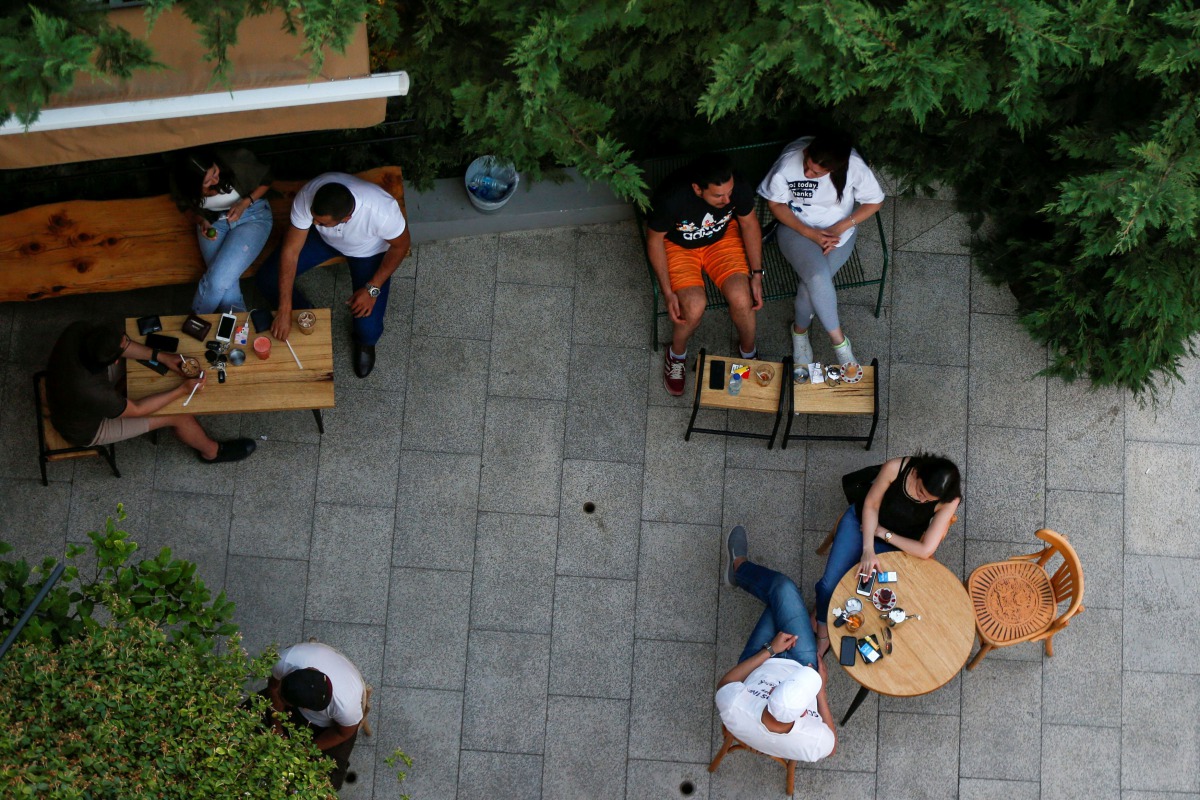 FILE PHOTO: People enjoy drinks at a cafe which reopened to the public for the first time since the start of the coronavirus disease (COVID-19) restrictions in Amman, Jordan June 6, 2020. REUTERS/Muhammad Hamed/File Photo