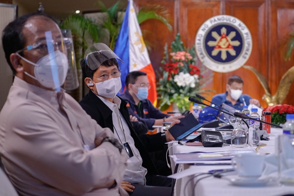 This handout photo taken on August 2, 2020 and received on August 17 from the Presidential Photo Division (PPD) shows Philippine Interior Minister Eduardo Ano (2nd L) attending an Inter-Agency Task Force on the Emerging Infectious Diseases (IATF-EID) meet