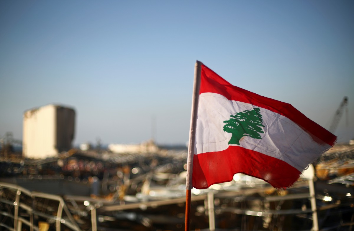 A Lebanese flag is pictured, in the aftermath of a massive explosion, in Beirut's damaged port area, Lebanon August 17, 2020. REUTERS/Hannah McKay
