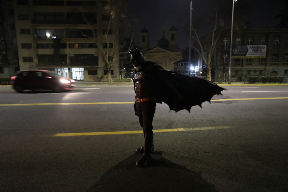A Chilean trader and so-called 'Batman solidario' (Solidarity Batman) walks after delivering charity food rations in the street, during the global outbreak of the coronavirus disease (COVID-19) in Santiago, Chile August 12, 2020. Picture taken August 12, 