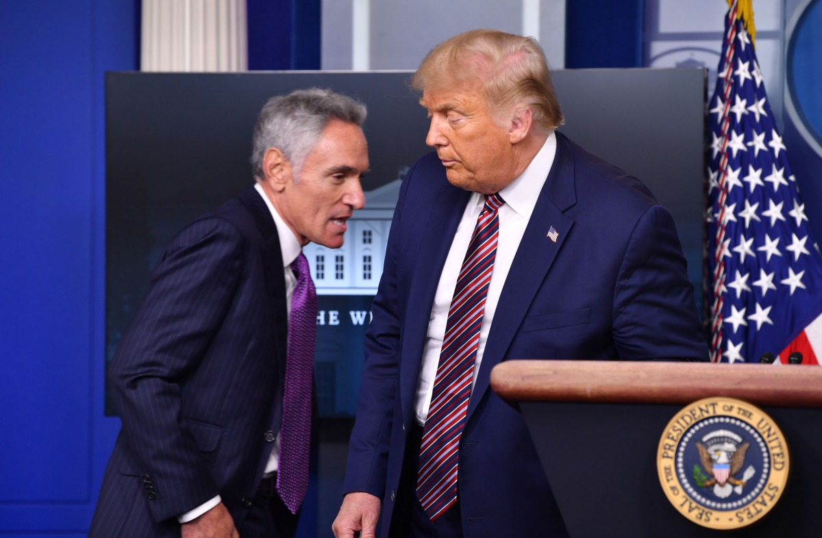US President Donald Trump introduces Senior Fellow at Stanford University's Hoover Institution, Dr. Scott Atlas, during a news conference in the Brady Briefing Room of the White House in Washington, DC, on August 12, 2020. / AFP / Nicholas Kamm

