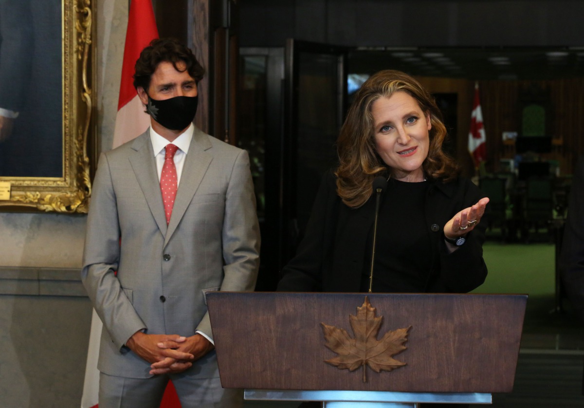 Canada's Deputy Prime Minister/Finance Minister Chrystia Freeland (R) speaks during a news conference on Parliament Hill August 18, 2020 in Ottawa, Canada, as Prime Minister Justin Trudeau looks. / AFP / Dave Chan 