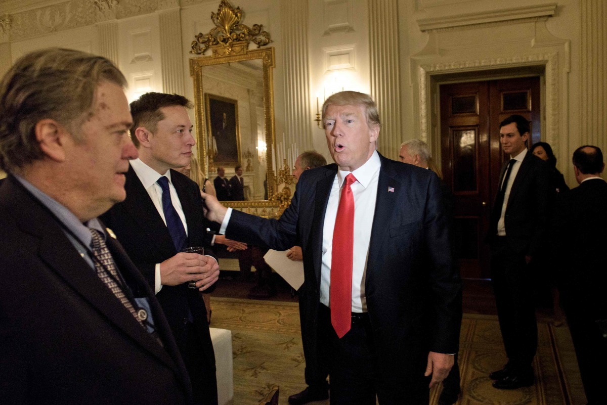 (FILES) In this file photo former Trump advisor Steve Bannon (L) watches as US President Donald Trump greets Elon Musk, SpaceX and Tesla CEO, before a policy and strategy forum with executives in the State Dining Room of the White House February 3, 2017 i