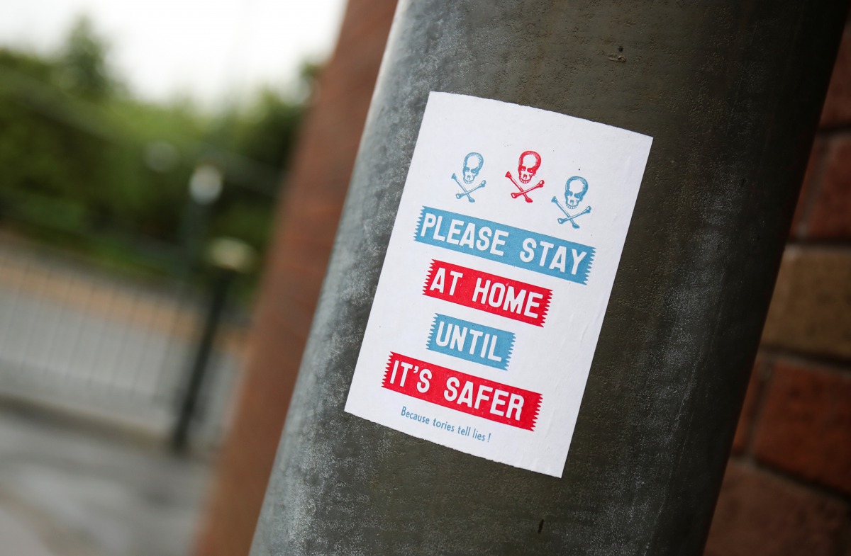 A view shows a sign advising people to stay home, amid the outbreak of the coronavirus disease (COVID-19), in Oldham, Britain, August 19, 2020. REUTERS/Molly Darlington
