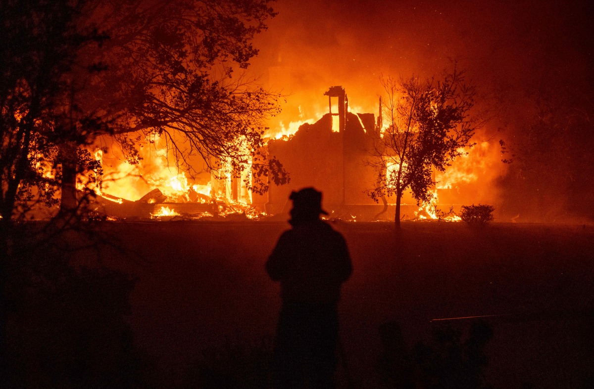 TOPSHOT - A home burns in Vacaville, California during the LNU Lightning Complex fire on August 19, 2020. As of the late hours of August 18,2020 the Hennessey fire has merged with at least 7 fires and is now called the LNU Lightning Complex fires. Dozens 