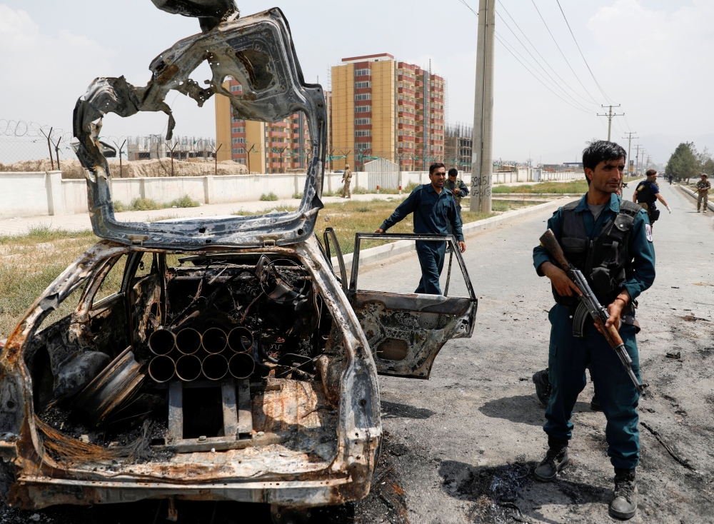 Afghan police officers inspect a vehicle from which insurgents fired rockets, in Kabul, Afghanistan August 18, 2020.REUTERS/Mohammad Ismail