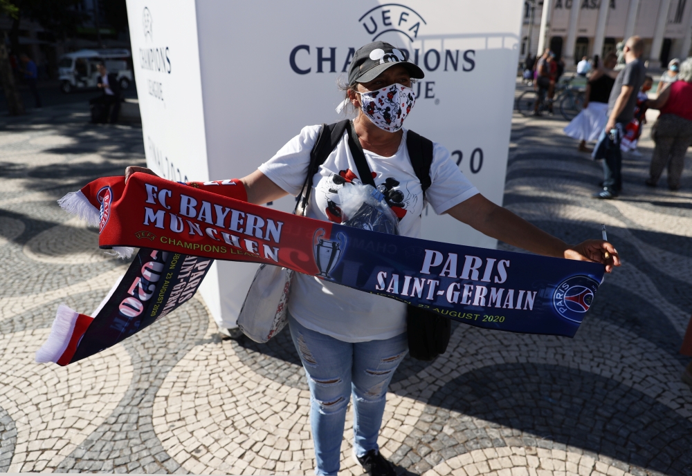 A fan poses with a scarf ahead of the Champions League final REUTERS/Rafael Marchante
 