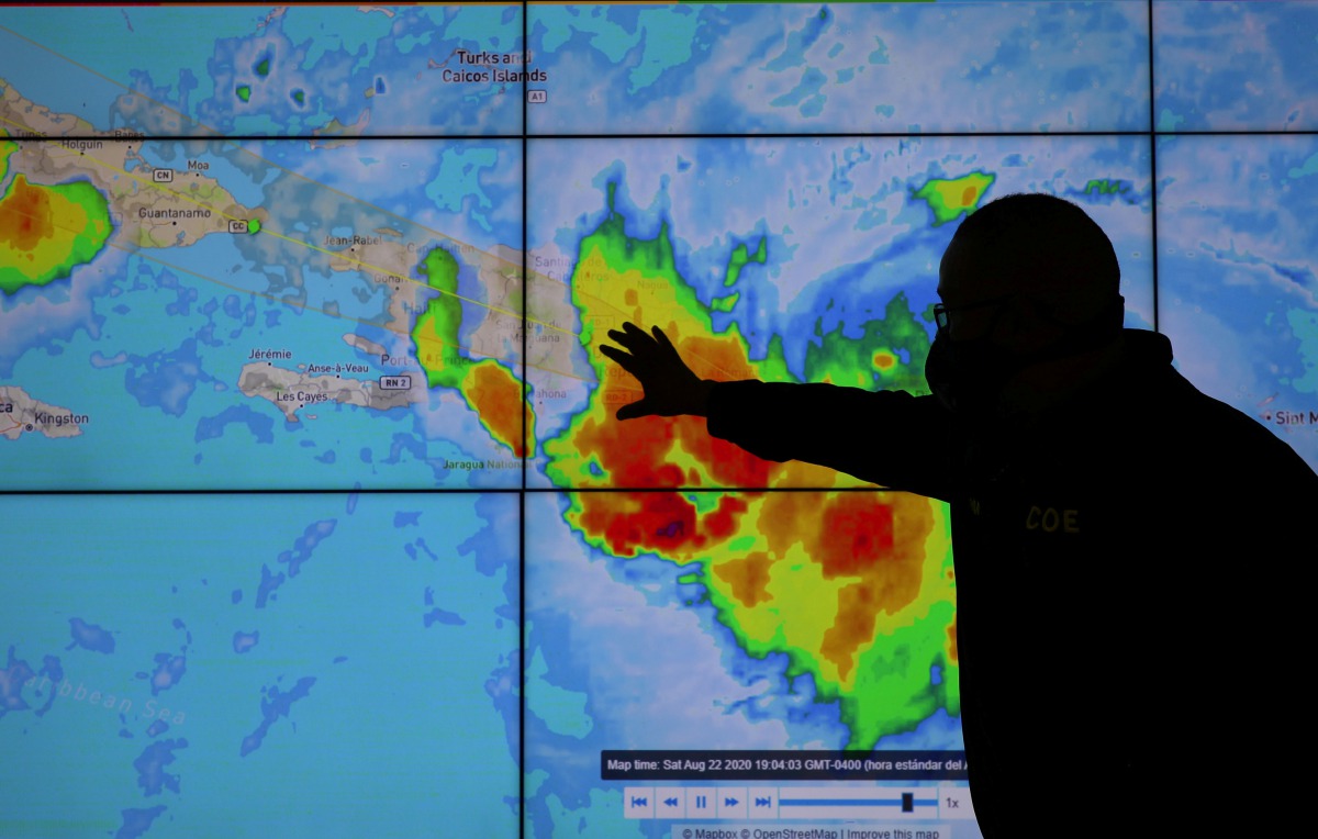 FILE PHOTO: A member of the Emergency Operations Committee (COE) monitors the trajectory of Storm Laura in Santo Domingo, Dominican Republic August 22, 2020. REUTERS/Ricardo Rojas -/File Photo
