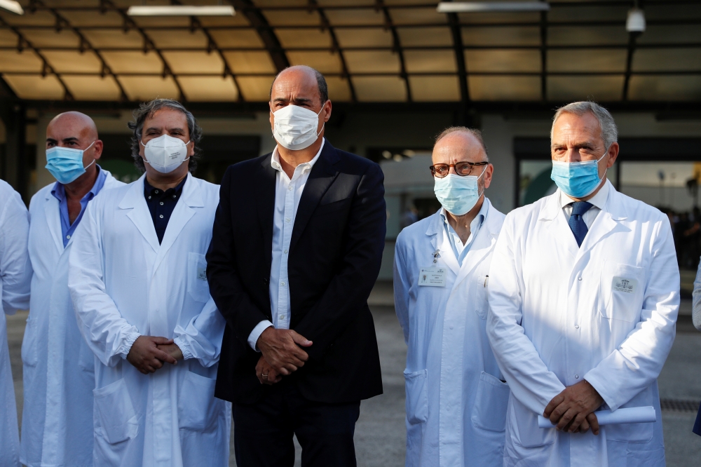 President of Lazio Nicola Zingaretti poses with medical staff at the Lazzaro Spallanzani infectious diseases hospital on the day of the first human trials of an Italian-developed coronavirus disease (COVID-19) vaccine, with doses administered to 90 volunt