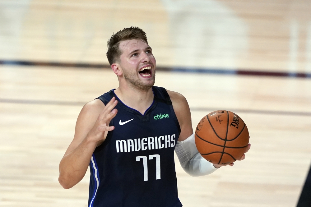 Lake Buena Vista, Florida, USA; Dallas Mavericks' Luka Doncic (77) reacts after being called for a foul against the Los Angeles Clippers during the first half of an NBA basketball first round playoff gameat AdventHealth Arena. Mandatory Credit: Ashley Lan
