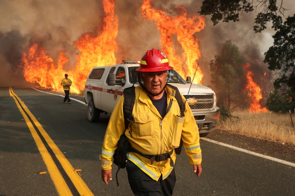 Chula Vista firefighter Rudy Diaz monitors the LNU Lightning Complex Fire as it engulfs brush in Lake County, California, U.S. August 23, 2020. REUTERS/Adrees Latif TPX IMAGES OF THE DAY