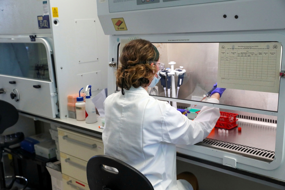 A scientist works during the visit of Britain's William, Duke of Cambridge, to the manufacturing laboratory where a vaccine against the coronavirus disease (COVID-19) has been produced at the Oxford Vaccine Group's facility at the Churchill Hospital in Ox