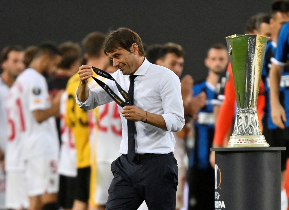 August 21, 2020 Inter Milan coach Antonio Conte with his runners up medal as he walks past the trophy after the match, as play resumes behind closed doors following the outbreak of the coronavirus disease (COVID-19) Martin Meissner/Pool via REUTERS/File P