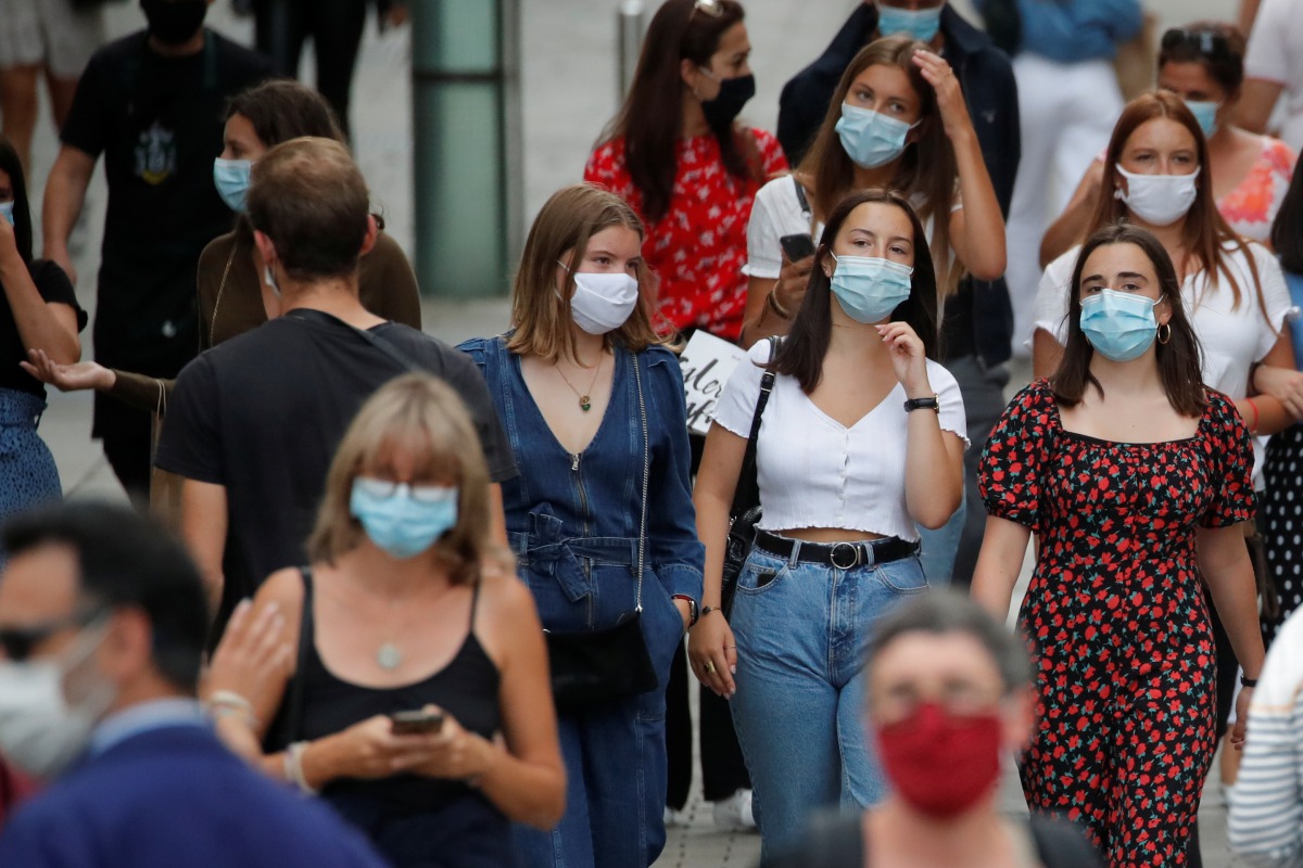 People wearing protective masks walk in a street in Nantes as France reinforces mask-wearing as part of efforts to curb a resurgence of the coronavirus disease (COVID-19) across the country, France, August 24, 2020. REUTERS/Stephane Mahe
