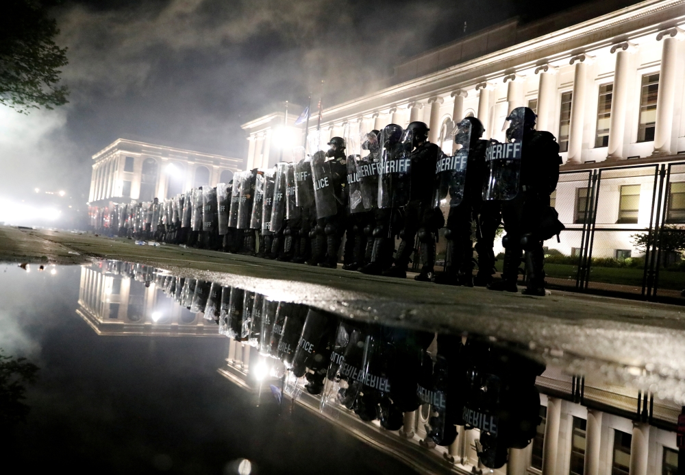 Law enforcement officers guard during a protest following the police shooting of Jacob Blake, a Black man, in Kenosha, Wisconsin, U.S. August 25, 2020. REUTERS/Brendan McDermid TPX