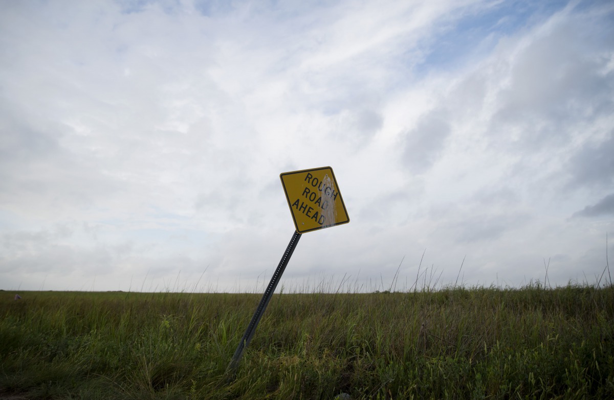 SABINE PASS, TX - AUGUST 26: A general view of a street sign in a field ahead of Hurricane Laura on August 26, 2020 in Sabine Pass, Texas. Hurricane Laura, currently a Category 4 storm, is expected to make landfall along the Gulf Coast late Wednesday and 