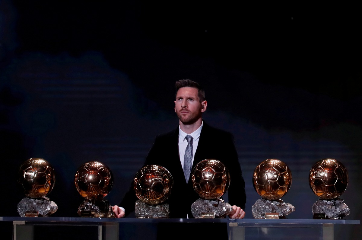 FILE PHOTO: Soccer Football - The Ballon d’Or awards - Theatre du Chatelet, Paris, France - December 2, 2019 Barcelona's Lionel Messi with his six Ballon d'Or trophies REUTERS/Christian Hartmann/File Photo
