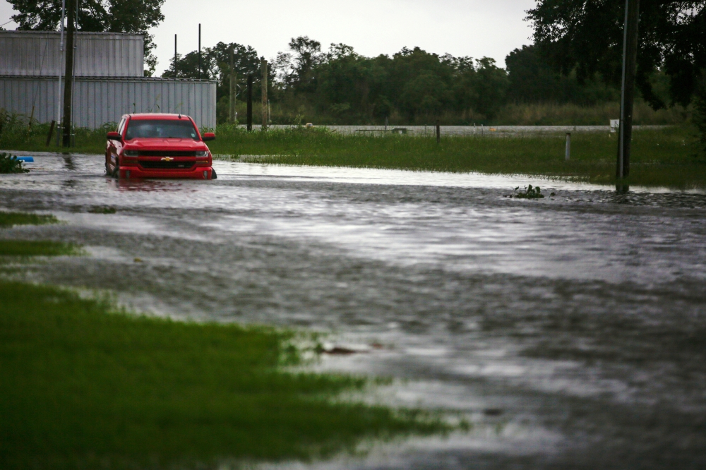 A car near Vermilion Bay is seen partially submerged in waters brought by Hurricane Laura approaching Abbeville, Louisiana, U.S., August 26, 2020. REUTERS/Kathleen Flynn REFILE - CORRECTING INFORMATION