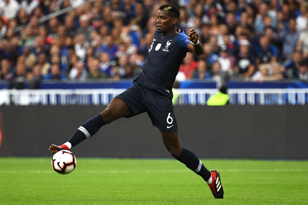 This file photo taken on September 10, 2018 shows France's midfielder Paul Pogba jumping for the ball during the UEFA Nations League football match between France and Netherlands at the Stade de France stadium, in Saint-Denis, northern of Paris. / AFP / A